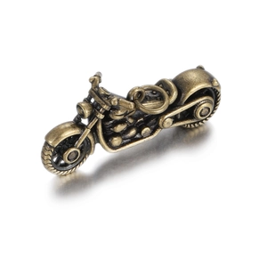Detailed macro view of vintage copper motorcycle pendant with engine and wheel texture