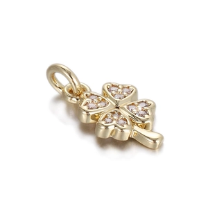 Macro shot of gold-plated clover pendant with heart-shaped leaves and micro-pave zircons