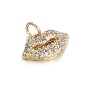 Detailed view of a gold-plated lip-shaped charm with pavé-set crystals and a hanging loop