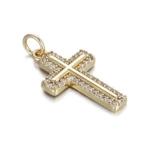 Macro shot of gold cross pendant with cubic zirconia stones and top hanging ring