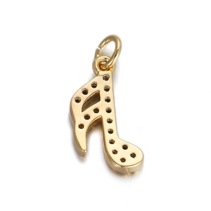 Detailed view of a golden music note pendant charm with intricate indentations for DIY jewelry