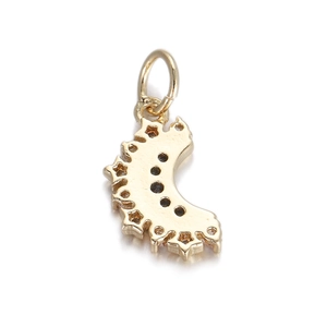 Detailed view of curved golden metal pendant with circular cutouts and star-shaped edges