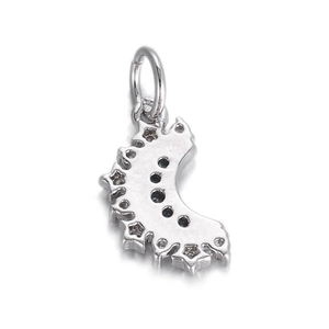 Detail of silver crescent pendant with star cutouts and black zircon stone inlay