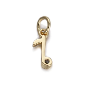 Detailed view of polished gold musical note pendant for DIY jewelry making