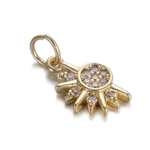 Detailed close-up of a gold-plated sunburst pendant with sparkling zircon micro-pave