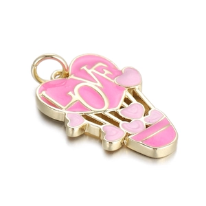 Macro detail of a gold heart hot air balloon pendant with pink enamel and LOVE engraving