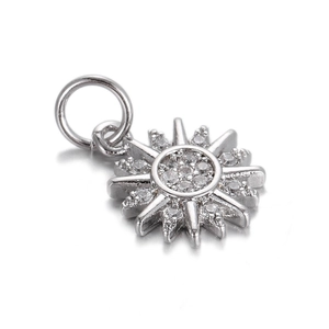 Macro shot of silver sunburst pendant with sparkling cubic zirconia stones