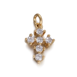 Detailed close-up of a golden cross pendant featuring six sparkling white cubic zirconia