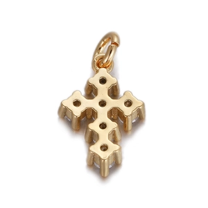 Close-up of golden cross pendant with sparkling clear zircon stones and hollow back detail