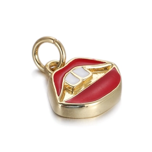 Detail of a red enamel lip-shaped pendant in gold metal for DIY jewelry making