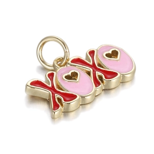 Macro view of gold-plated XOXO heart pendant with red and pink enamel detailing