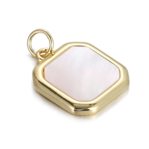 Macro shot of square gold-rimmed pendant with pink mother-of-pearl inlay and ring
