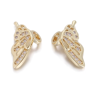 Detail of golden butterfly jewelry pendants with clear zircon stones on white background