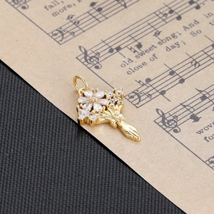 Macro shot of gold floral bouquet pendant with sparkling drop-shaped clear zircons