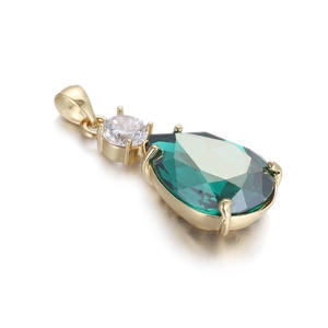 Détail macro du pendentif en zircon vert poire avec monture à griffes dorée et fini brillant