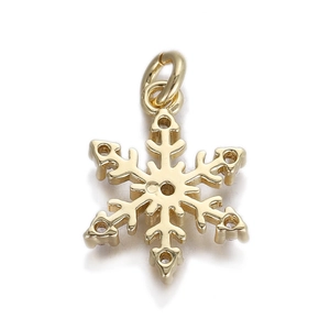 Detailed close-up of a golden snowflake charm with polished finish and top ring for DIY jewelry