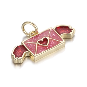Macro view of gold envelope heart pendant with pink glitter wings and metal ring