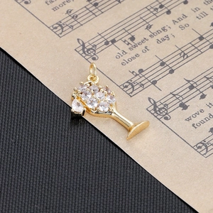 Macro view of golden wine glass pendant with sparkling clear zirconia crystals for DIY jewelry