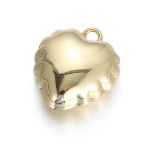 Macro detail of a golden heart pendant featuring unique wavy textured edges and top ring