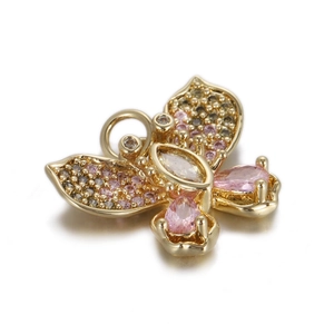 Detail of butterfly pendant featuring pink gems and cubic zirconia in gold plating
