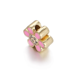 Macro view of gold-plated flower charm with pink enamel and micro-set zircon