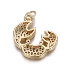 Macro view of gold crab pendant with micro-pave stone holes and hanging ring for jewelry