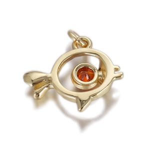 Close-up of a gold fish pendant with a vibrant orange stone inlay and high-polish finish
