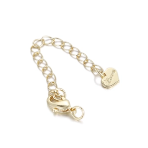 Close-up of gold plated jewelry extension chain with lobster clasp and Love heart charm