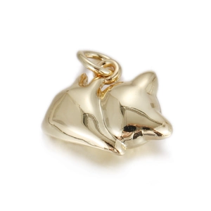 Macro detail of sleeping fox pendant in polished gold finish for necklaces