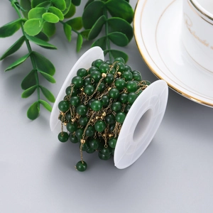 Detailed view of dark green stone beads on gold stainless steel chain for DIY jewelry