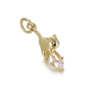Macro shot of gold cat pendant featuring a sparkling pink heart-shaped gemstone