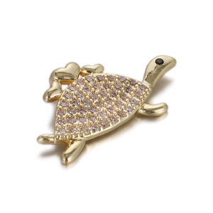 Macro view of golden turtle pendant with zircon inlay and heart-shaped shell details
