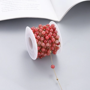 Detail of red natural stone beads on gold stainless steel chain for DIY jewelry making