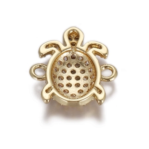 Macro view of gold-tone turtle charm back with hollow holes for jewelry DIY