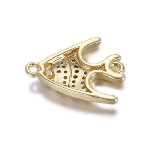 Macro shot of gold-plated fish pendant with textured finish and polished surface for DIY