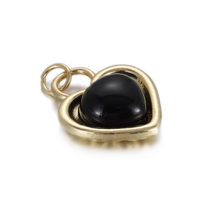 Detail of a heart-shaped black stone pendant with gold-plated frame and double jump rings