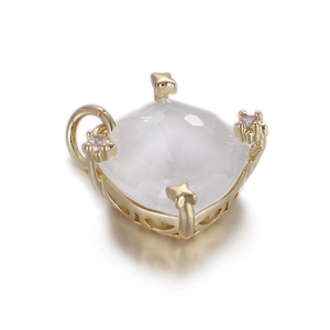 Macro view of gold-plated heart pendant with translucent stone and zircon claw details