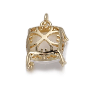 Macro detail of gold plated square pendant base with hollow floral patterns and claw setting