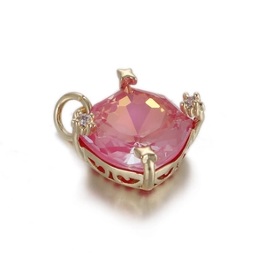 Macro shot of pink heart zircon pendant with gold filigree base and star diamond accents