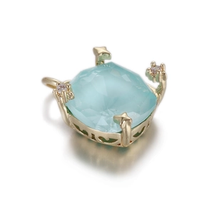 Detailed macro view of light blue faceted heart pendant with golden star-shaped setting