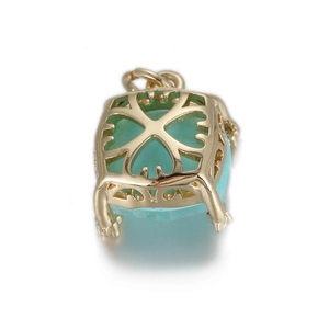 Macro view of gold-plated heart pendant back with intricate floral cutout pattern