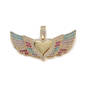 Close-up of golden heart wing pendant with multi-colored zirconia stones and fine details