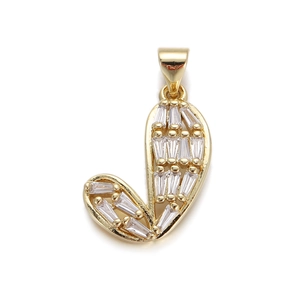 Macro detail of gold-plated letter J pendant featuring baguette-cut white zircons