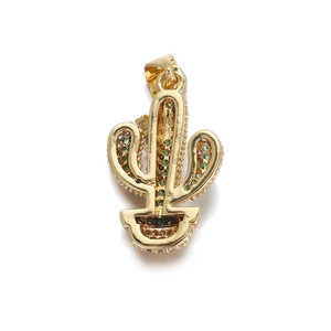 Macro detail of a gold cactus pendant featuring green cubic zirconia and potted design