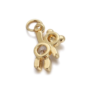 Detailed macro view of a golden bear jewelry pendant with a round clear zircon stone