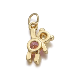 Detail view of a golden bear charm with pink zircon inlay for jewelry making