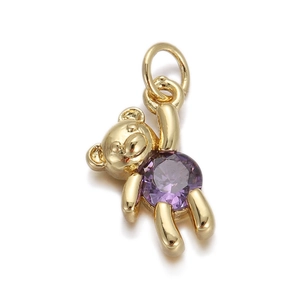 Detailed view of a golden bear charm with a sparkling purple round cubic zirconia stone