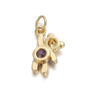 Detail of golden bear pendant with a purple zircon stone inlay and secure metal loop