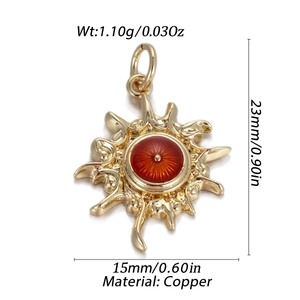 Detail view of gold sunburst pendant with red center and dimensions of 23mm by 15mm