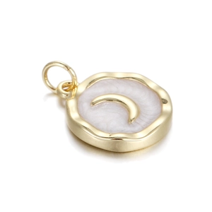 Macro detail of round golden pendant with white textured inlay and crescent moon charm